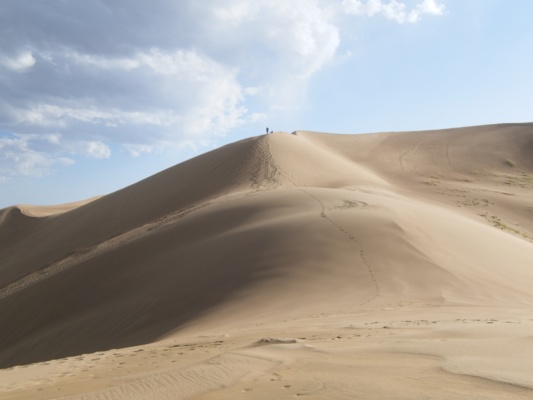 A hiker on the path to High Dune