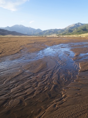 Water that originates in the mountains slowly seeps into the sand