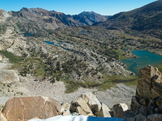 A steep drop-off separates me from the glacially-carved valley below sierra high route cross country