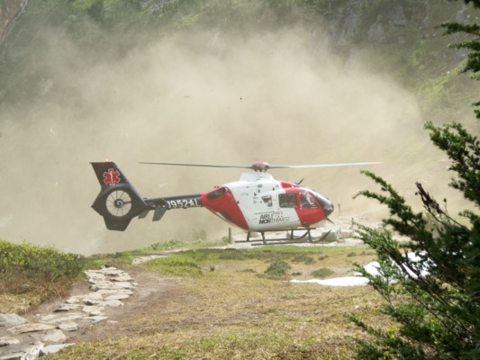 An airlift helicopter lands at Cascade Pass to evacuate an injured hiker cascade pass