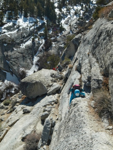 Kim clambers up a series of granite steps mount whitney mountaineers route