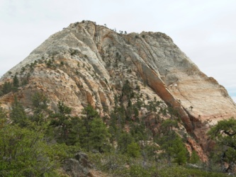 We hike around this stony peak; do you see the tiny patches of snow? zion national park pine valley peak