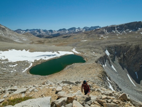 Sully scrambles up the west ridge of Polychrome Peak with our "little" lake below polychrome peak