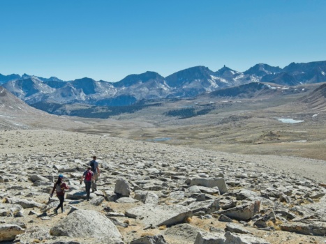 Sully, Bartek, and Craig navigating easy talus and gravel back to camp with the awe-inspiring Great Western Divide in the background sierra nevada mountains