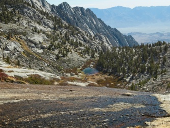 The runoff from the lakes above streams over the granite slabs whitney mountaineer's route