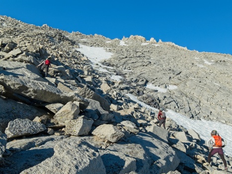 Bartek, Sully, and Judy scrambling through the talus. You can just make out a little notch at the top of the rib that we're climbing toward (the highest one, farthest left) mount tyndall