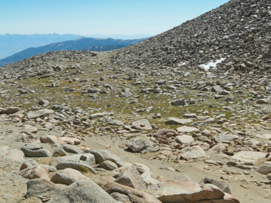 A small plateau holds enough water to support some grass lamarck col trail