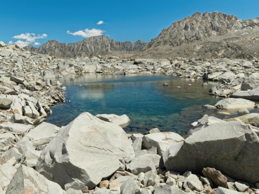 I stop to eat lunch beside this bright blue tarn on the saddle between Wanda Lake and the Davis Lake basin sierra nevada mountains
