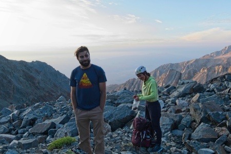 We stop for a snack and bathroom break as the sun rises mountaineering