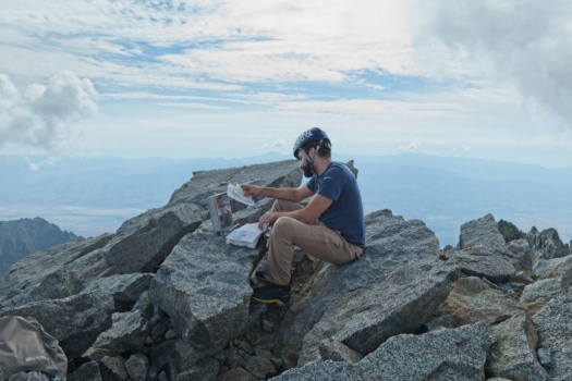 Alex peruses the summit register split mountain