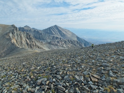 Kim hikes up the expansive slope that leads to the summit split mountain