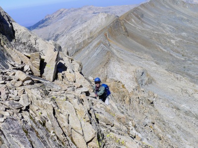 I scramble up some class 3 rock on the Triple Divide Peak ridge. Photo credit: Craig triple divide peak