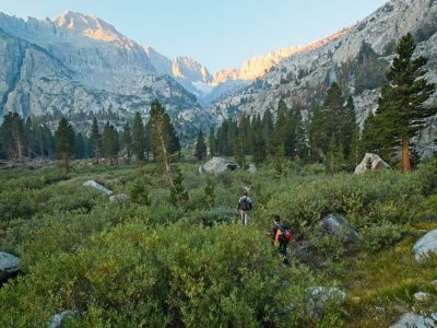 Craig and Jeff follow a use trail through a meadow en route to Elinore Lake palisades