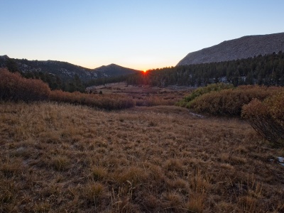 The sun peeks over the mountains dawn