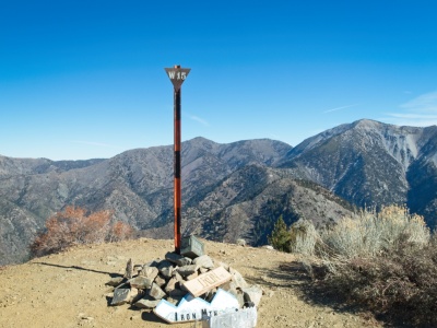 A pile of signs and rocks mark the summit of Iron Mountain iron mountain