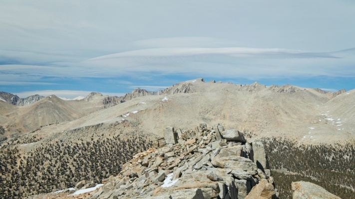 A view of Mount Whitney from Mount Guyot with a cool lenticular cloud above the ridge mount whitney