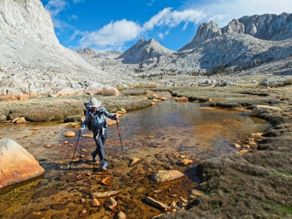 Daniel dances from rock to rock across the creek miter basin