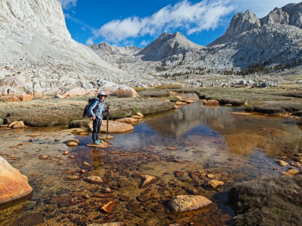 Diane pauses mid-creek crossing, grinning ear-to-ear at the beautiful scenery miter basin