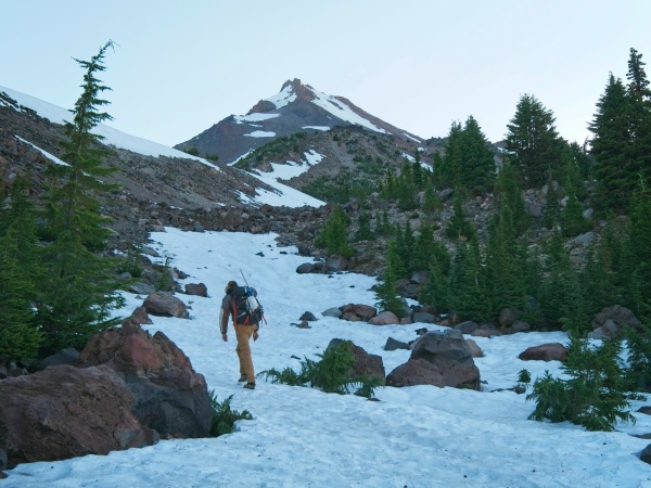 Craig walks up an icy snow slope mount jefferson