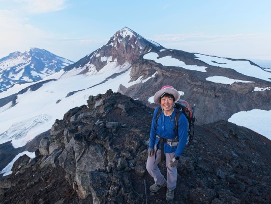 Linda poses for a photo in front of South and Middle Sisters three sisters
