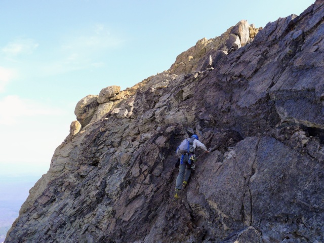I scramble up the summit block. Photo credit: Craig north sister summit