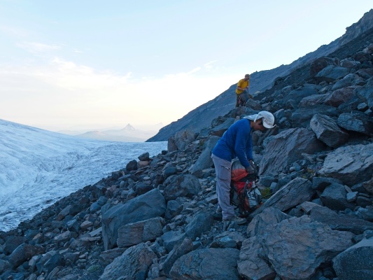 Craig and Linda pull helmets out of their packs before beginning of the loose climb up to the south ridge north sister