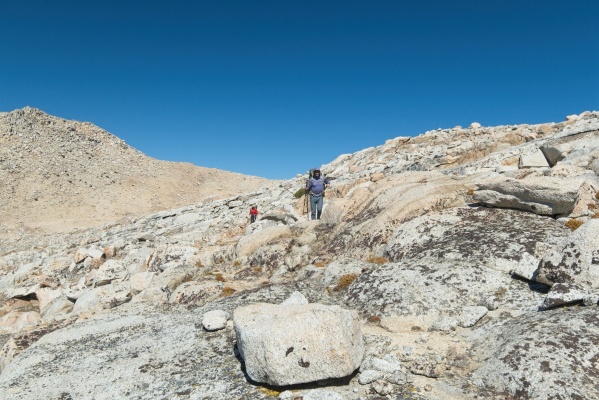 Alex and Kim work their way across a landscape of granite slabs cross country hiking