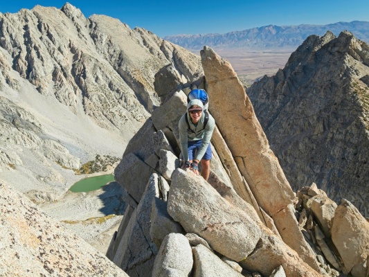 John scrambles across an exposed section of the ridge mount humphreys