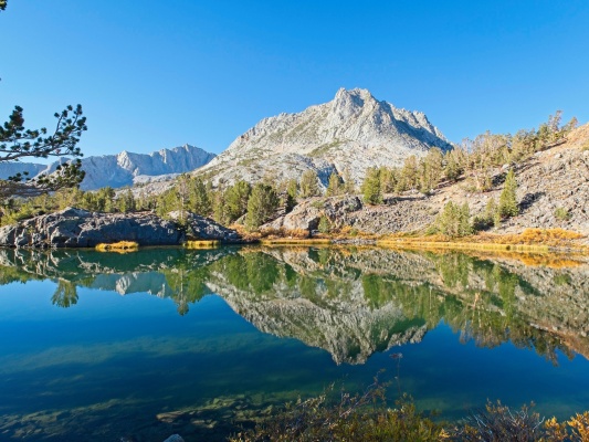 Hurd Peak reflects in the glassy surface of Long Lake long lake