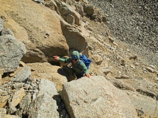 Josh prepares to scramble up a rocky step below Mount Sill scree climbing