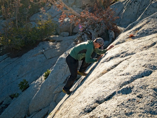 Josh scrambles up a crack just for kicks rock climbing