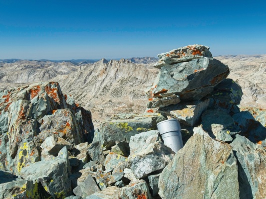 The Twin Peaks summit register is nestled between lichen-covered rocks twin peaks summit