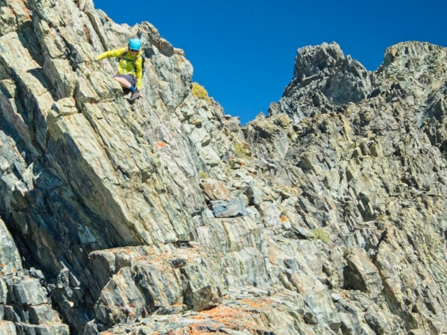 Dagmar climbs down an exposed rock during the traverse to Virginia Peak twin peaks ridge