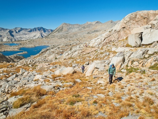 Josh and Alex hike up a grassy slope in Dusy Basin dusy basin