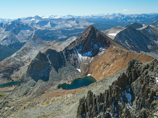 Virginia Peak looms over an unnamed lake with Yosemite's Cathedral Range stretching across the horizon. virginia peak