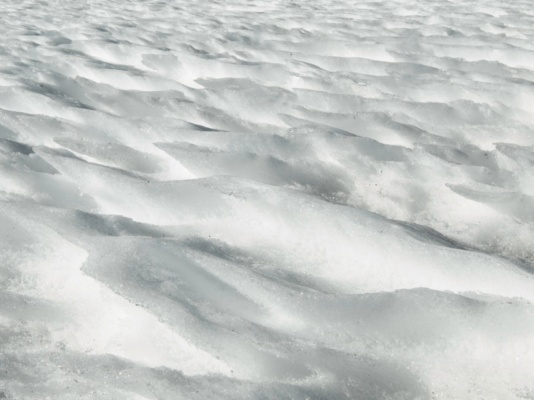 Icy fins of snow protrude at an angle snow