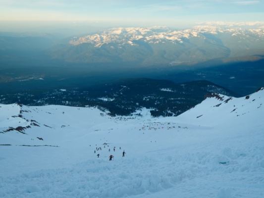 Looking down at our tent city and the newly-sunlit peaks across the valley mount shasta avalanche gulch