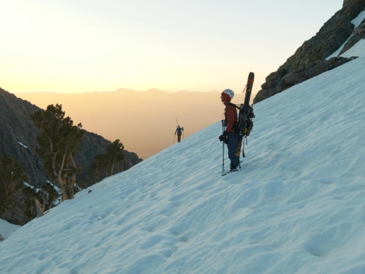 Sunrise paints the sky gold ski mountaineering