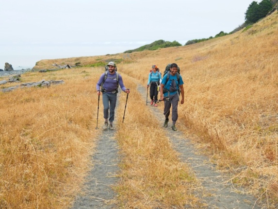 Alex, Kim, and CK strolling down a double-wide trail lost coast trail