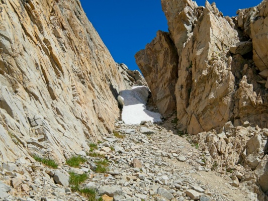 I squeeze between the snow and the cliff on the right to begin the climb to West Vidette west vidette