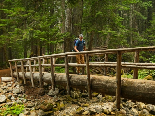 Craig B. crosses a bridge glacier peak trail
