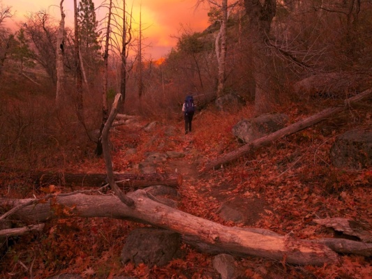 The sunset light paints the landscape red autumn backpacking