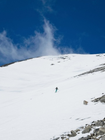 Skiing down from the summit birch mountain ski mountaineering