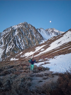 Maddie treks through the brush with her gear birch mountain ski mountaineering