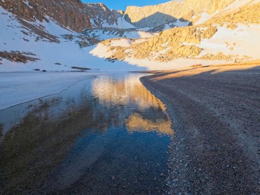 There's a little liquid water at the lake to refill water bottles alpine lake