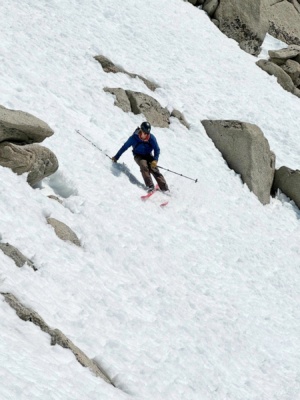 Andrew begins skiing down the couloir ski tour