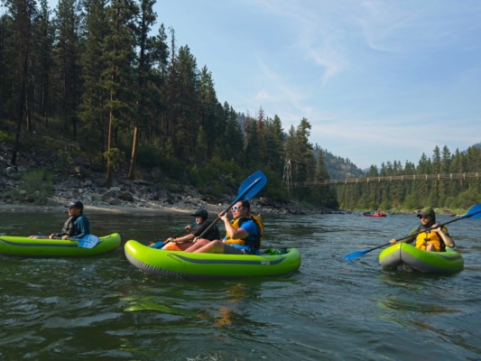 Gabe, Mason, Noah, and Brian paddling down the river main salmon river rafting