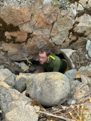 Brian crawls out of a narrow mine tunnel main salmon river rafting
