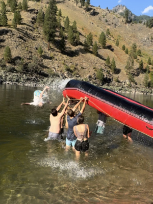 Mason does a front flip off of the raft main salmon river rafting