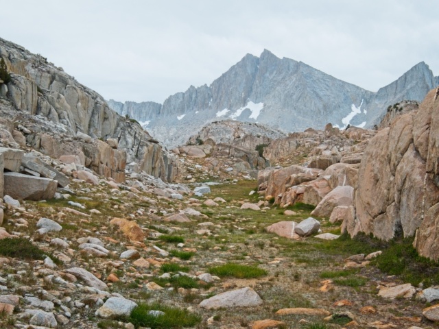 A grassy "sidewalk" leads directly toward Seven Gables seven gables